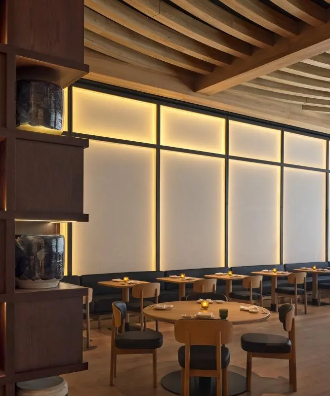Dining room with lowered shades glowing from warm backlighting
